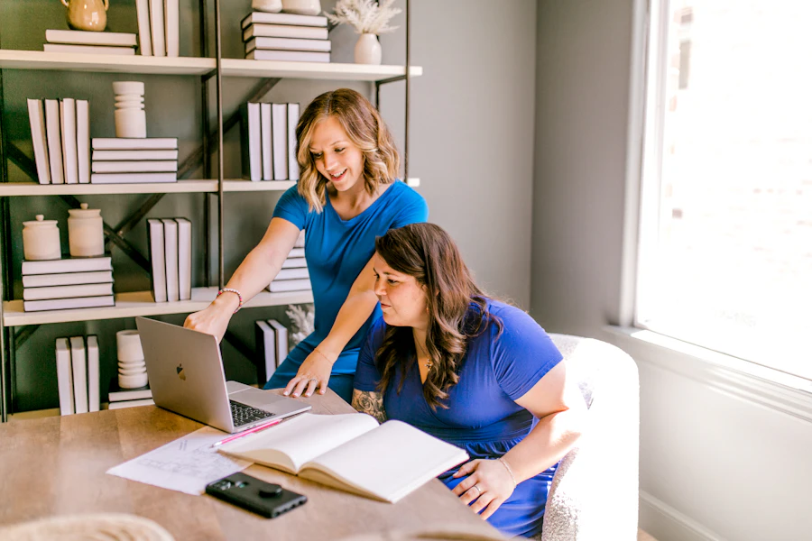 Two colleagues collaborating on a laptop