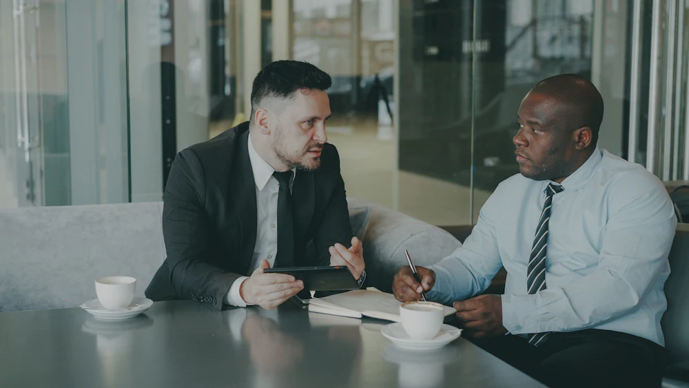 Consultants discussing a business process over coffee